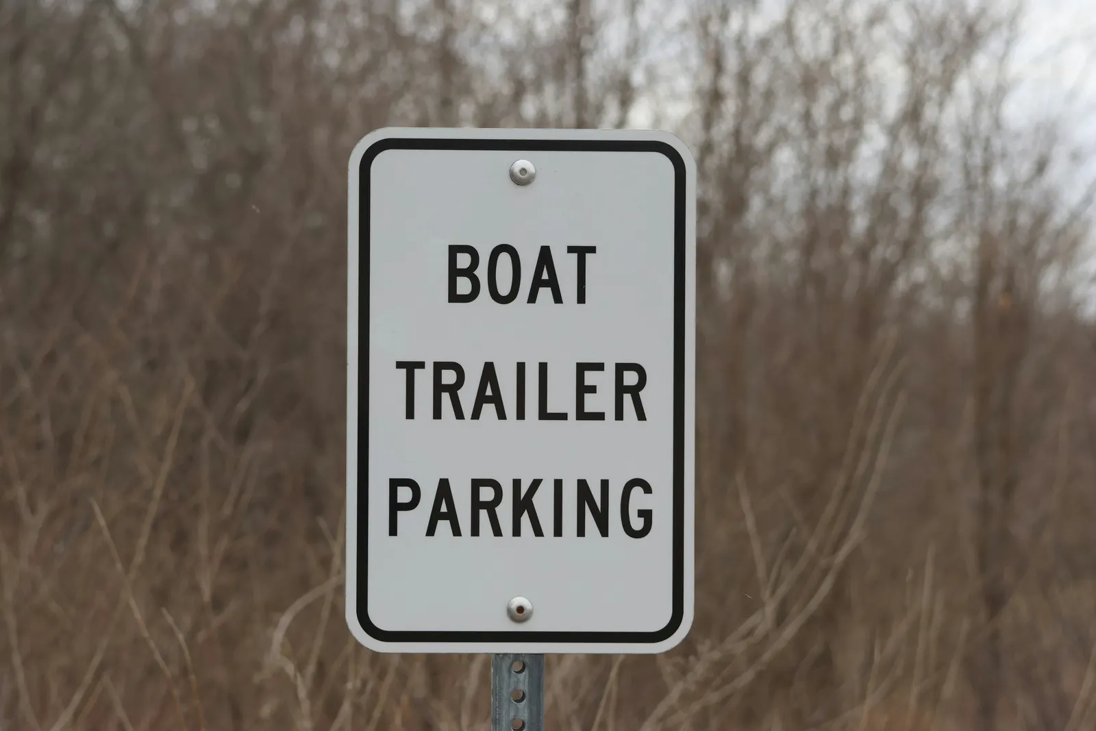 Boat trailer parking sign at the entrance to an outdoor storage lot