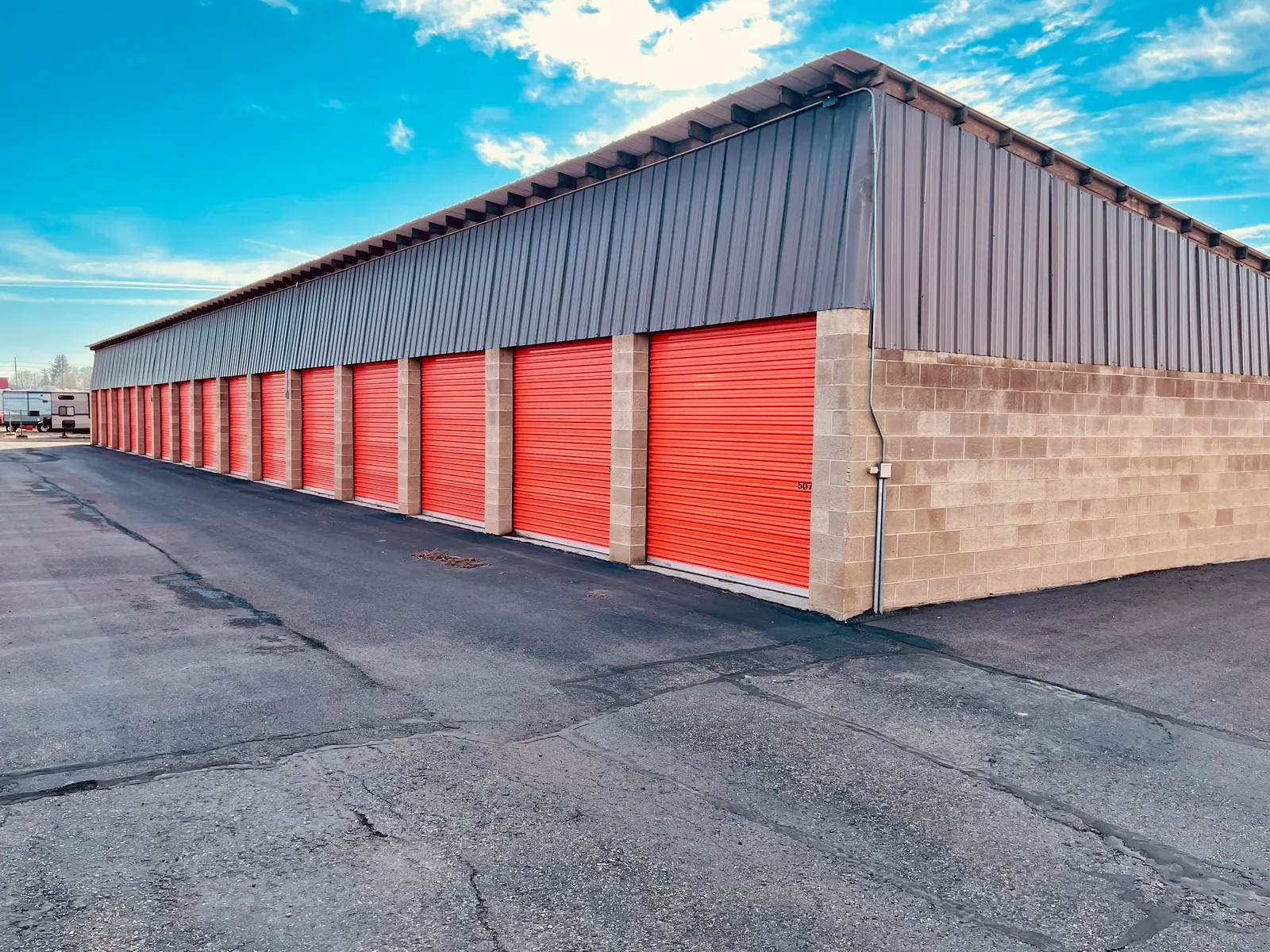 Row of storage units with red roll-up doors