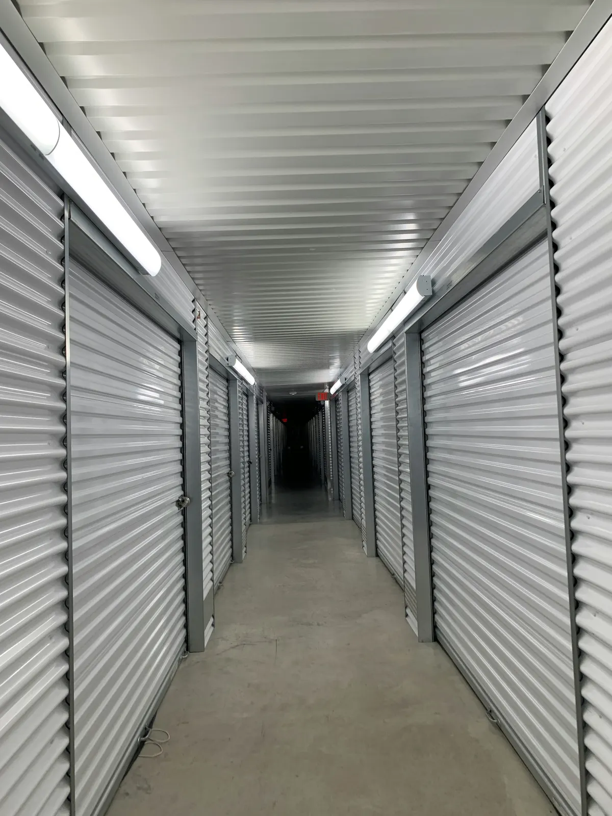 Row of climate-controlled indoor storage units with roll-up doors